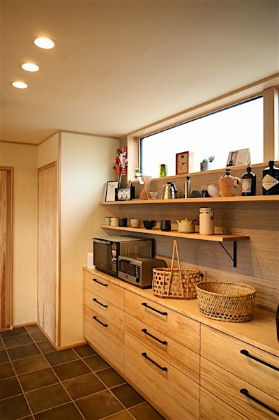 キッチンの背面側はジョリパッド仕上げで空間のアクセントに。お気に入りのツールをディスプレイ。