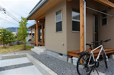 室内干し場からアクセスするウッドデッキで外干しもできる。道路から見えにくい位置に配置した。