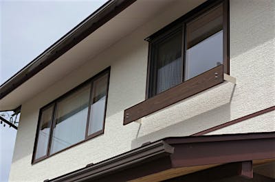 窓下に設けた布団干しバーが、外観のアクセントにもなる。