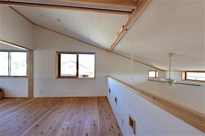 2階には広々としたゲストスペース。屋根形状に合わせて下がる斜天井が面白い空間。